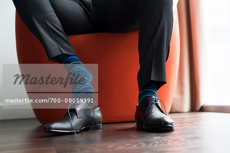 Close-up of Groom with Striped Socks Putting on Shoes