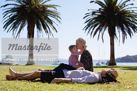 Mother and daughter hugging in coastal park, New Zealand