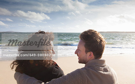 Couple relaxing on beach, Connemara, Ireland