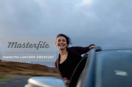 Woman leaning out of car window, Connemara, Ireland