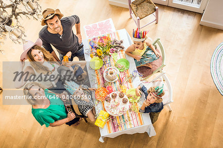 Overhead portrait of three generation family at kids birthday party
