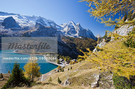 The majestic Marmolada Group and the Lake Fedaia with its turquoise waters, Dolomites, Italy, Europe