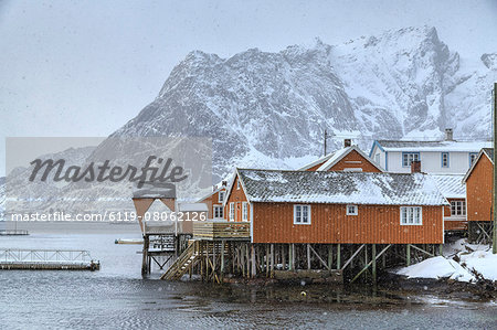 A violent and sudden snowstorm begins to fall in the Bay of Hamnoy famous for Rorbu cottages in the Lofoten Islands, Hamnoy, Lofoten Islands, Arctic, Norway, Scandinavia, Europe