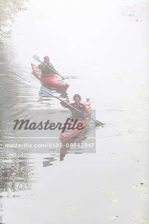 Women kayaking in fog