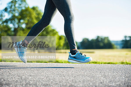 Woman jogging on country road