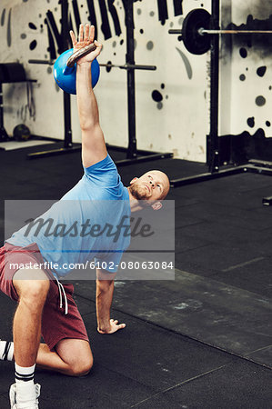 Man training in gym with kettlebell