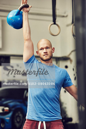 Man training in gym with kettlebell