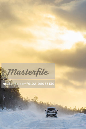 Car on country road at sunset