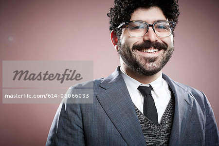 Portrait of young man, looking at camera, smiling