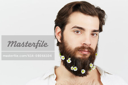 Portrait of man with flowers in beard