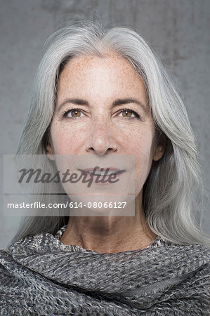 Portrait of beautiful mature woman with long grey hair