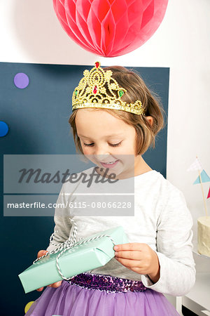 Birthday party, girl in costume holding present, Munich, Bavaria, Germany