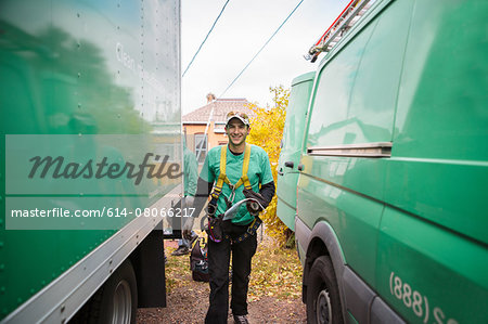 Solar panel installation worker walking in between truck and van