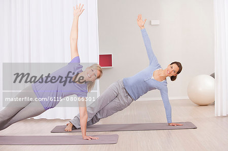 Two women doing Pilates exercises
