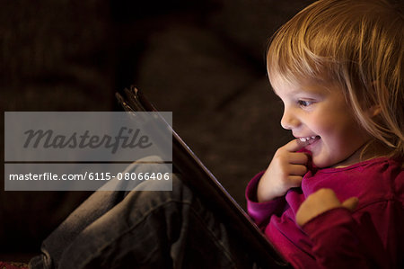 Blond girl using digital tablet