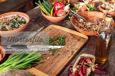 Fresh parsley on cutting board among variety of ingredients