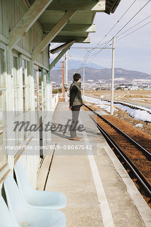 Young Japanese man having a train trip across Japan