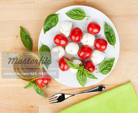 Caprese salad plate on wooden table