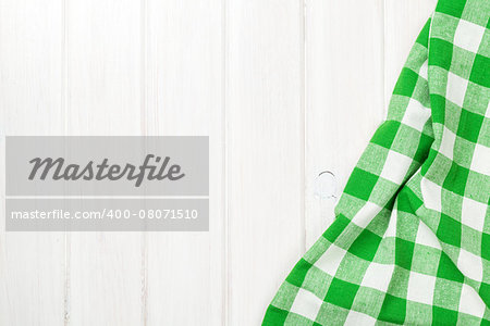 Green towel over wooden kitchen table. View from above with copy space