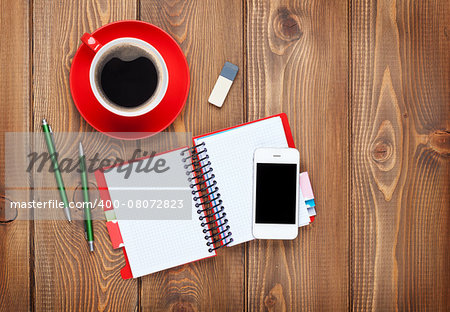 Office desk table with supplies and coffee cup. Top view with copy space