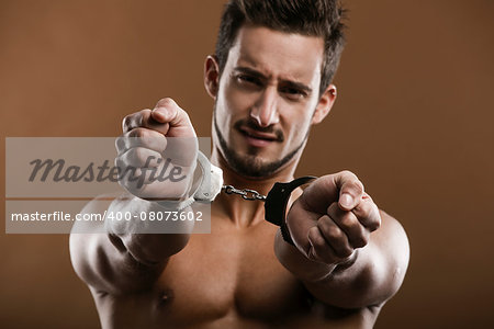 Handsome young man arrested with handcufs on his hands