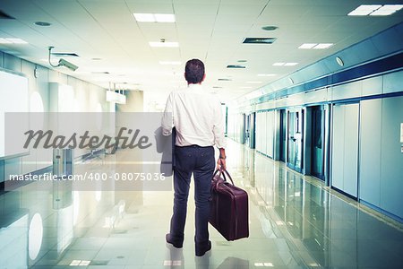 Businessman in airport ready to travel with aircraft