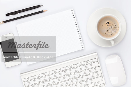 Office desk table with computer, supplies and coffee cup. Top view with copy space