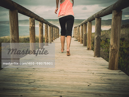 Beautiful and healthy woman running on a path