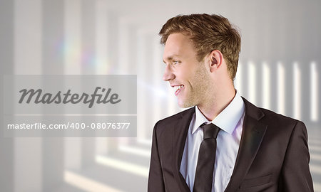 Young handsome businessman looking away against curved white room