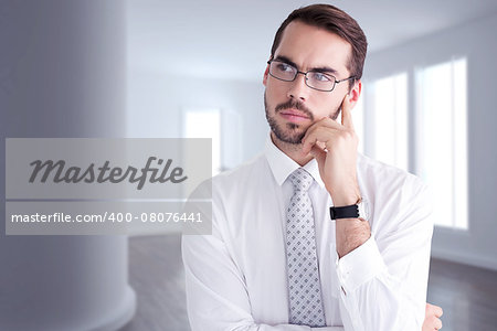 Portrait of a businessman with glasses thinking  against bright room with windows