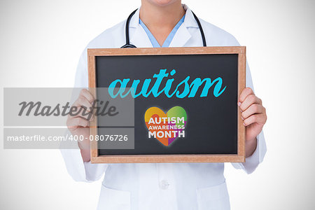 The word autism and doctor showing little blackboard against autism awareness month