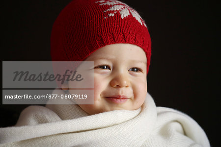 A 15 months baby boy with a cap and a scarf A 15 months baby boy with a cap and a scarf