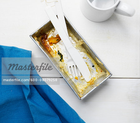 Overhead View of Empty Lasagne Container with Cutlery, Studio Shot