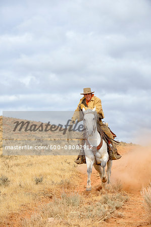 Cowboy Riding Horse with Rope in Hand, Shell, Wyoming, USA