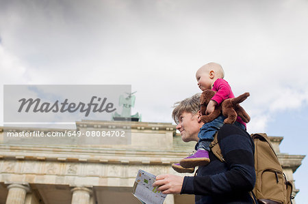 Father sightseeing whilst giving baby daughter shoulder ride, Brandenburg Gate, Berlin, Germany