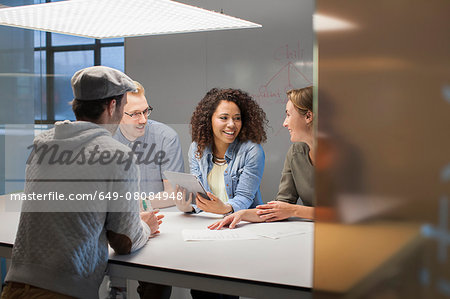 Four creative colleagues meeting at conference table