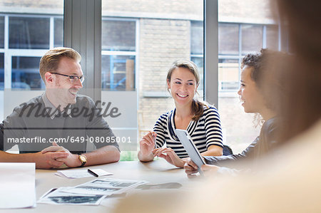 Design team meeting at conference table in creative office