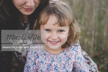 Close up portrait of young girl and mother