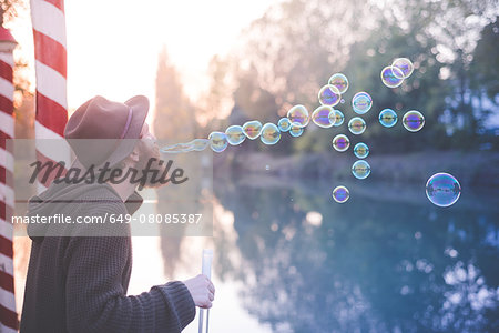 Young man blowing bubbles