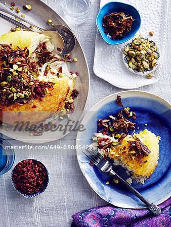 Still life of Iranian tahchin with rice, chicken and yogurt