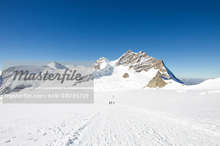 View of tracks in snow covered mountain landscape, Jungfrauchjoch, Grindelwald, Switzerland