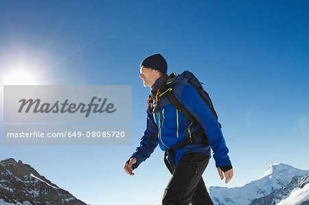 Man hiking in snow covered mountains, Jungfrauchjoch, Grindelwald, Switzerland