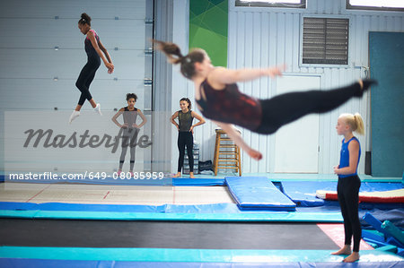 Young gymnasts practising moves