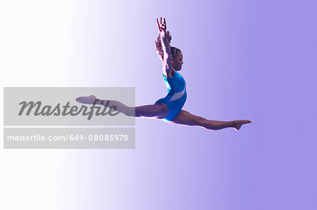 Young gymnast in mid-air leap