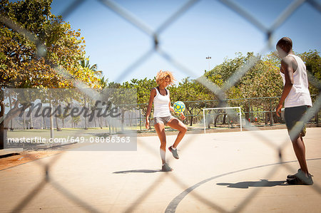 Young couple practicing together on basketball court