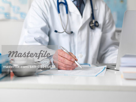 Doctor checking medical notes before prescribing treatment