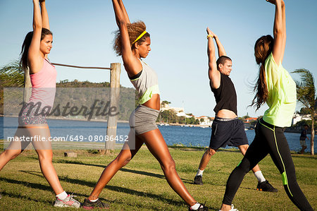 Three young women stretch training in  park