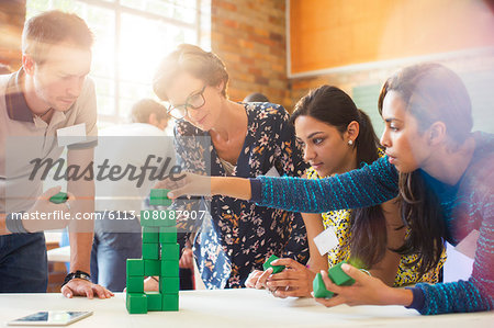 Creative business people stacking green blocks