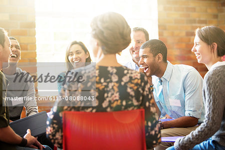 People laughing in group therapy session