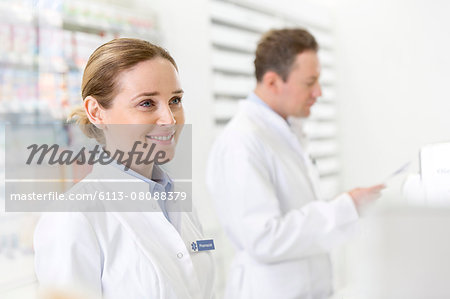 Smiling pharmacist in pharmacy